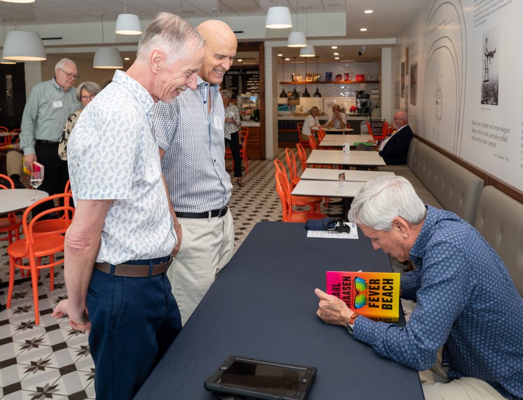 Carl Hiaasen signing his latest book