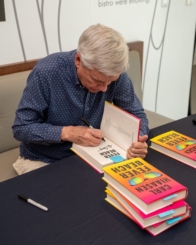 Carl Hiaasen signing his latest book